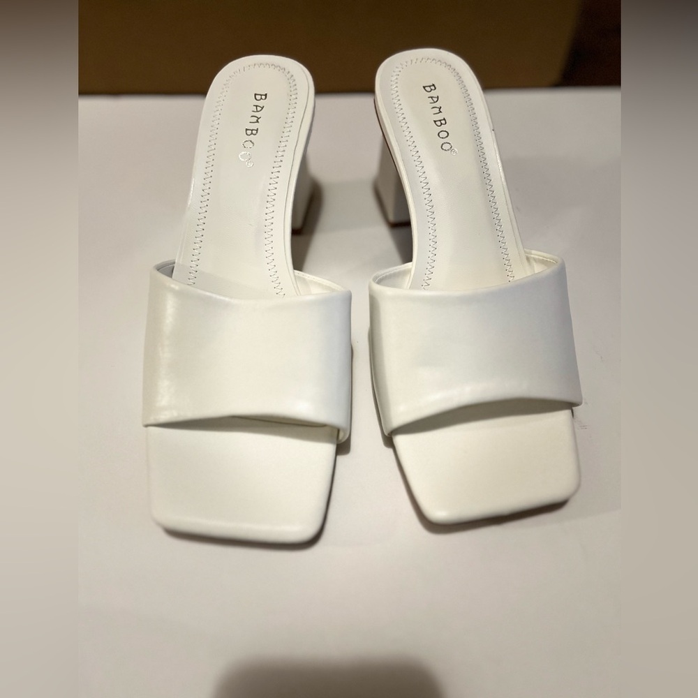 White mules. Mid heel.